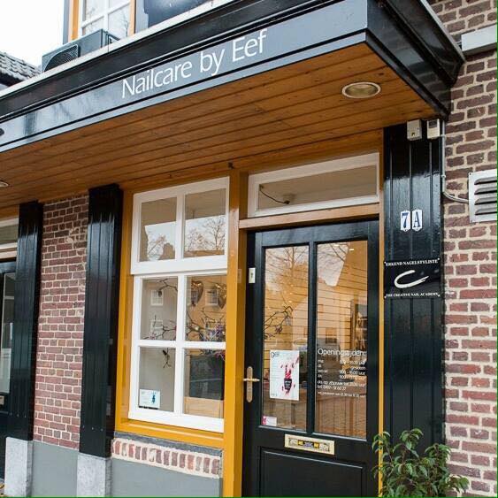 Pand van nailcare by Eef. Zwart hout afdak met gele raamkozijnen.